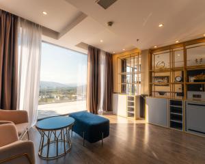 a living room with a table and a large window at Sevsamora Resort & Spa in Saguramo