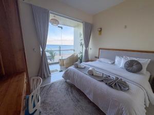 a bedroom with a bed with a view of the ocean at Mora Mila in Arugam Bay +80 photos