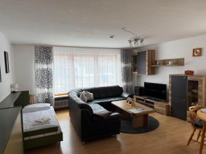 a living room with a couch and a table at Alpenblick am Kienberg in Pfronten