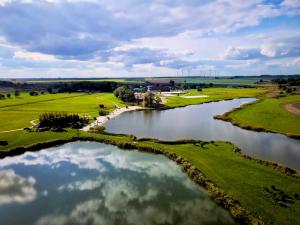 an aerial view of a golf course and a river at Hotel Jakubus in Wilków