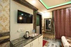 a bathroom with a tv on the wall and a sink at Hotel Royal Sen in Lālbhitti