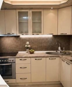 a kitchen with white cabinets and a sink at Villa BESA - BA Debar in Debar