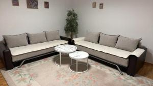 a living room with two couches and two tables at Villa BESA - BA Debar in Debar +1 photo