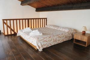 a bedroom with a bed with towels on it at Azienda Agrituristica Le Puzelle in Santa Severina