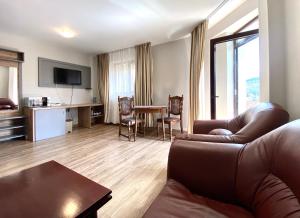 a living room with a couch and a table at Vila Predeal Holidays in Predeal