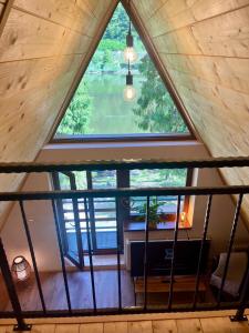 an attic view of a room with a large window at Green-in in Jaklovce
