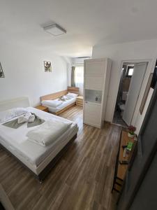 a small bedroom with a bed and a bathroom at Oxygen Rooms in Hunedoara
