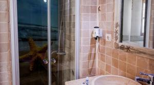 a bathroom with a shower with a starfish in it at Çökertme Butik Otel in Çökertme