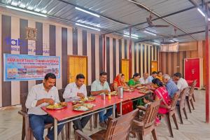a group of people sitting at a table eating food at FabHotel Shree Ram Aadhar 900 Mtr from Ram mandir in Ayodhya