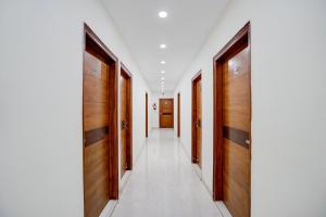a corridor with wooden doors at Super Townhouse Krishna Nagar Metro Station in New Delhi
