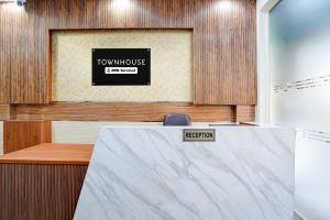 a room with a table with a sign that reads town house at Super Townhouse Krishna Nagar Metro Station in New Delhi