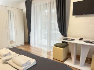 a living room with a white table and a window at Hotel Palas Grand View in Iaşi