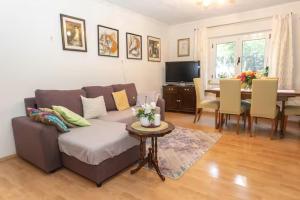 a living room with a couch and a table at House Roso in Makarska