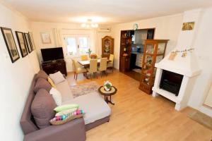 a living room with a couch and a fireplace at House Roso in Makarska