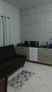 a living room with a couch and a kitchen at Casa Napolitana in Uruguaiana +5 photos