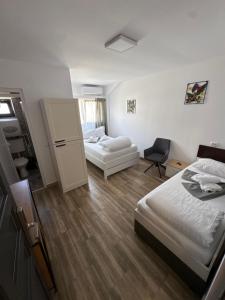 a hotel room with two beds and a couch at Oxygen Rooms in Hunedoara +30 photos