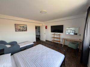 a room with two beds and a flat screen tv at SeaEsta Studio in Agigea