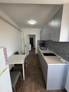 a kitchen with white cabinets and a counter top at SeaEsta Studio in Agigea