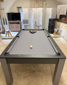 a pool table with a ball on top of it at Mas du pommier Gala in Gagnières