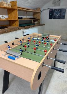 a wooden table with a game of billiards at Mas du pommier Gala in Gagnières +15 photos