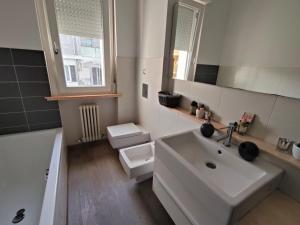 a bathroom with a sink and a toilet and a mirror at Il giardino di Ely in Senigallia +48 photos