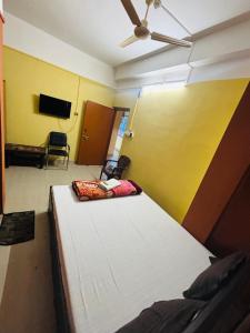 a bedroom with a bed and a ceiling fan at The Pinnacle Stays in Guwahati +16 photos