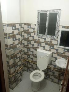 a bathroom with a toilet and a sink at The Pinnacle Stays in Guwahati