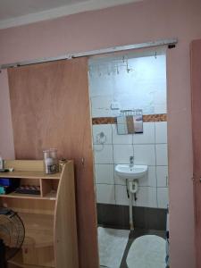 a bathroom with a sink and a toilet and a mirror at DELAILOA ADVENTURES Homestay with Tom in Nadi +18 photos