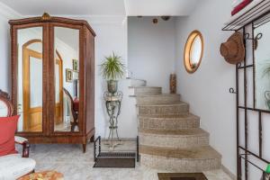 a staircase in a living room with a mirror at Crestuma Bright Apartment, by Hopstays in Crestuma +48 photos