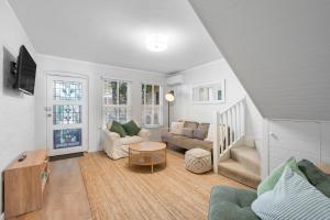 a living room with a couch and a table at Central Freo Hideaway in Fremantle