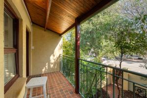 a porch with a white chair on a balcony at Central Freo Hideaway in Fremantle