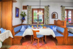 a dining room with a table and chairs at Land Wirtschaft Höß in Bad Feilnbach