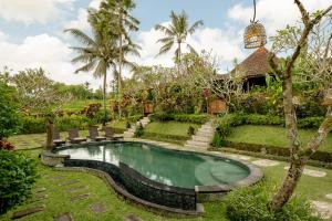 a pool in the yard of a villa at KERAMAN SUITE UBUD in Ubud