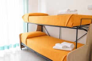 a couple of bunk beds in a room at Azzurro Beach Hotel Igea Marina in Bellaria-Igea Marina +45 photos