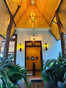 a person standing in front of a door with trees at Eagle View villa in Ella
