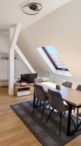 a living room with a dining table and a skylight at Voyage Pension in Leipzig