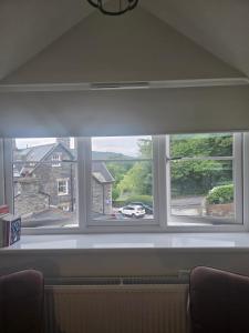a window in a living room with a view of a house at Marie House in Bowness-on-Windermere