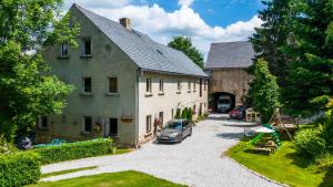 a house with a car parked in front of it at Przytulne Siedlisko in Jugowice