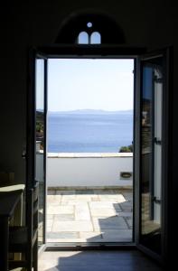 a door leading into a room with a view of the ocean at Rosalie Home - Open Sea Studio in Tinos +7 photos