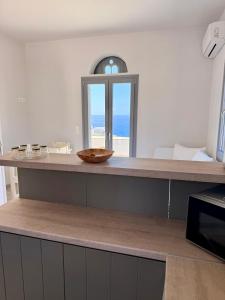a kitchen with a counter with a bowl on it at Rosalie Home - Open Sea Studio in Tinos