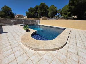 a swimming pool in a patio with at Chalet Paradise of the Mediterranean in La Nucía