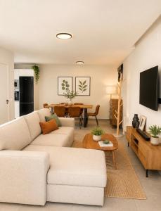 a living room with a white couch and a table at La casa Suiza in Cercedilla