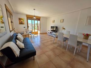 a living room with a couch and a table at Chalet Paradise of the Mediterranean in La Nucía
