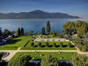 an aerial view of a park next to a lake at Fairmont Le Montreux Palace in Montreux