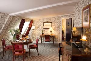 a living room with a table and chairs and a dining room at Hotel Residence Des Arts in Paris