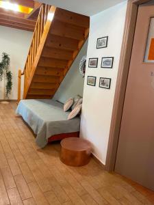 a bedroom with a bed and a stair case at Rodi House in Lygia