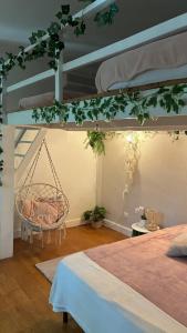 a bedroom with two beds and a hanging swing at Maison de ville exceptionnelle in Carpentras