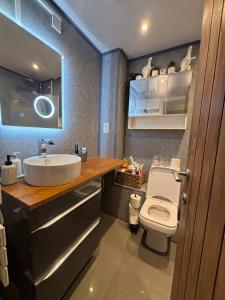 a bathroom with a white toilet and a sink at Cosy home in Edinburgh in Edinburgh +10 photos