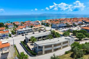 an aerial view of a city with the ocean at Pefki Deluxe Residences - Adults Only 16plus in Pefkochori +55 photos