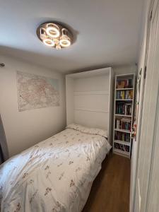 a small bedroom with a bed and a book shelf at Cosy home in Edinburgh in Edinburgh